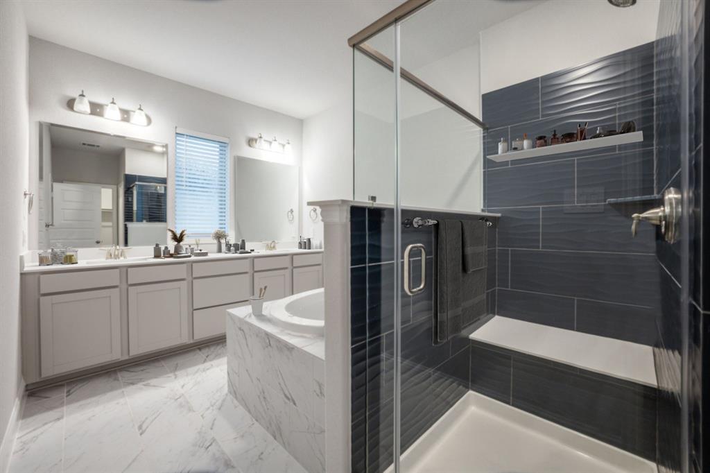 7833 Sunset Boulevard Rowlett, TX 75088 - Photo 11 of 20 a bathroom with a sink a toilet a mirror and shower