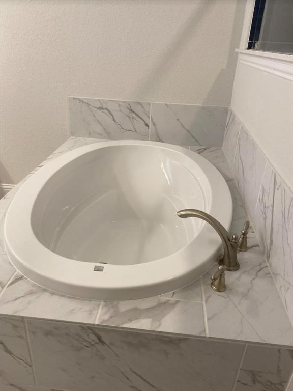 7833 Sunset Boulevard Rowlett, TX 75088 - Photo 14 of 20 a close up of a bathtub