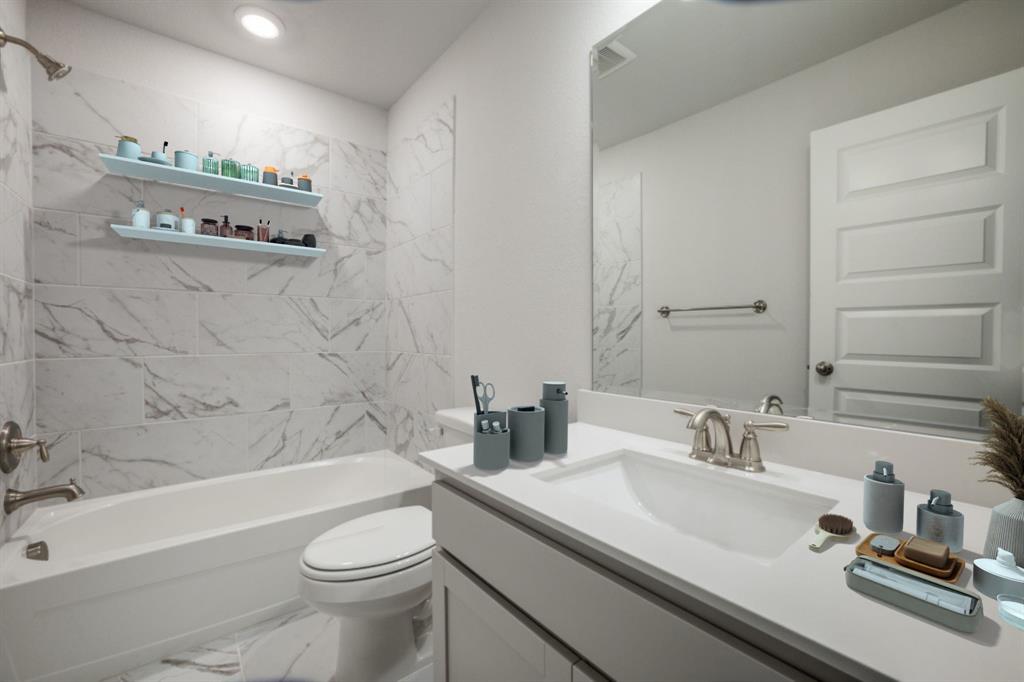 7833 Sunset Boulevard Rowlett, TX 75088 - Photo 16 of 20 a bathroom with a sink a toilet and shower