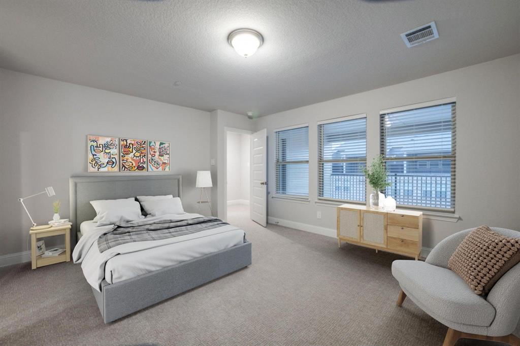 7833 Sunset Boulevard Rowlett, TX 75088 - Photo 17 of 20 a spacious bedroom with a bed and glass window