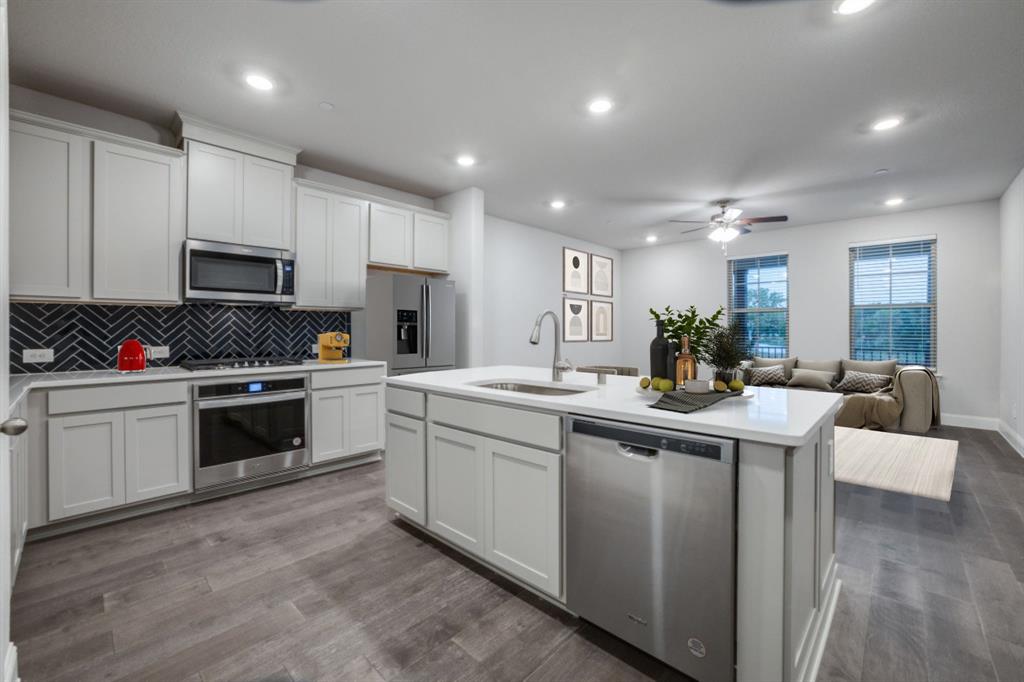7833 Sunset Boulevard Rowlett, TX 75088 - Photo 4 of 20 a kitchen with sink cabinets and stainless steel appliances