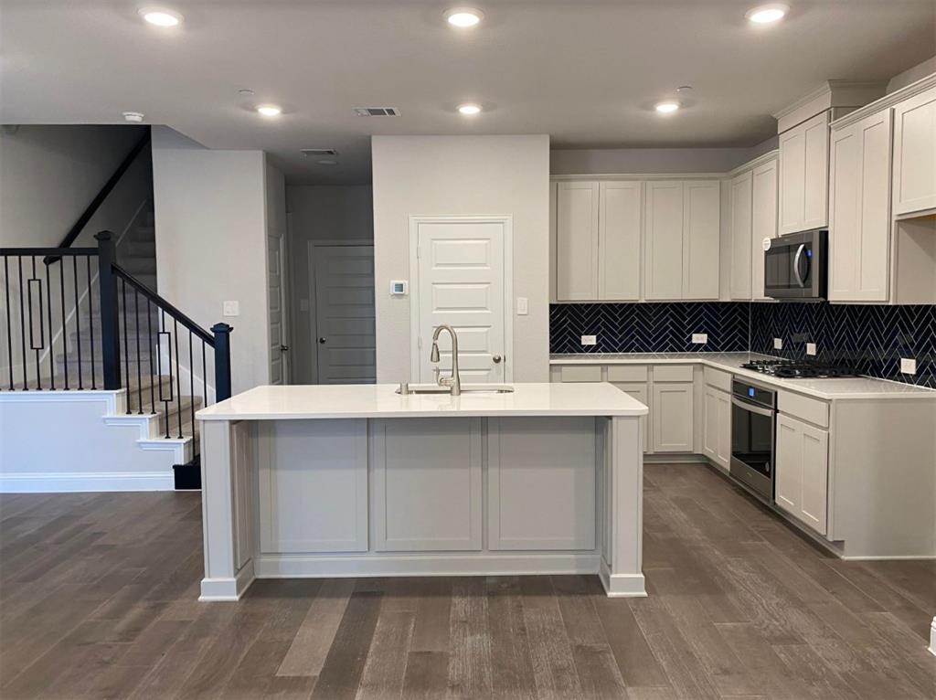 7833 Sunset Boulevard Rowlett, TX 75088 - Photo 5 of 20 a kitchen with a sink cabinets and appliances