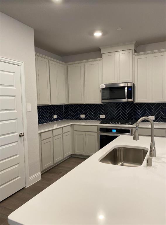 7833 Sunset Boulevard Rowlett, TX 75088 - Photo 6 of 20 a kitchen with a sink and cabinets