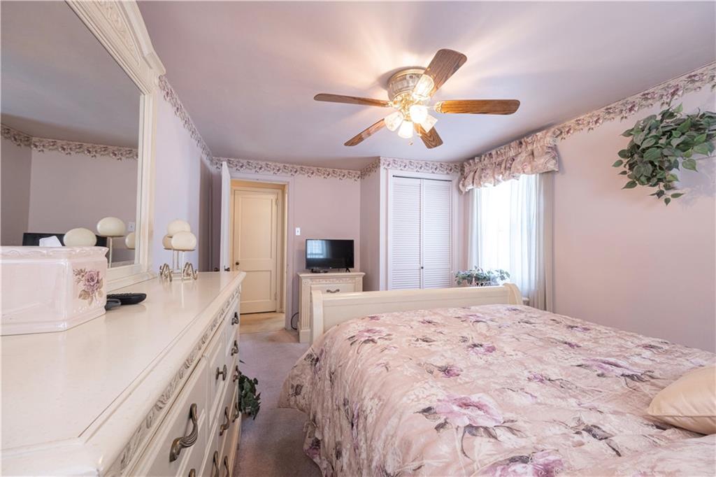 2511 McNeilly Road Pittsburgh, PA 15226 - Photo 16 of 23 a spacious bedroom with a bed and a chandelier