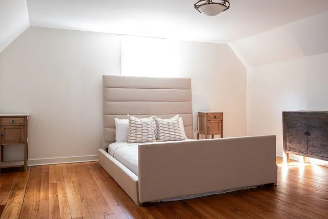 a view of a garden with an ocean from a balcony