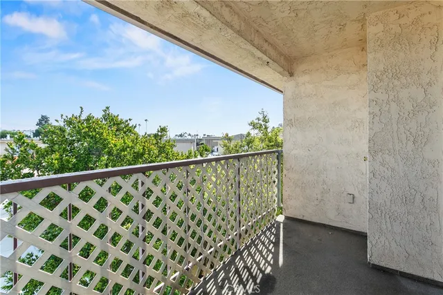 a view of a balcony with wooden fence