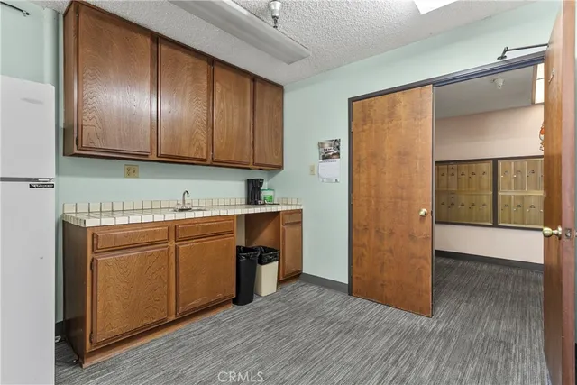 a kitchen with granite countertop wooden cabinets and stainless steel appliances