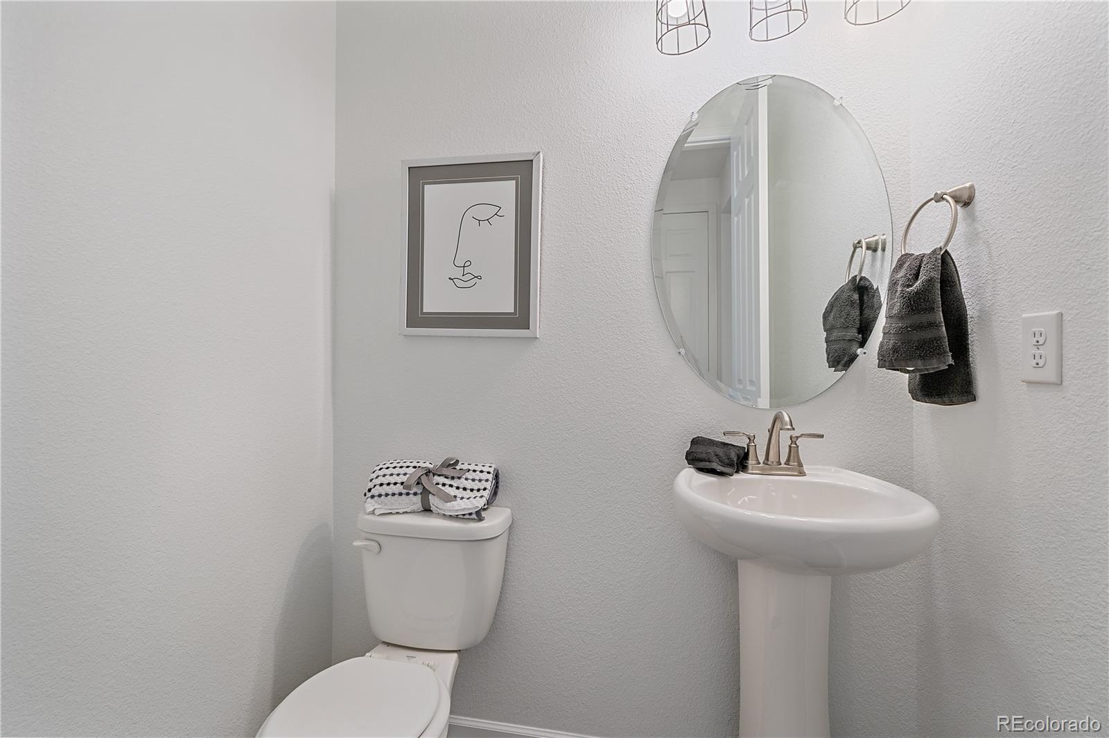 5465 Gray Wolf Lane Castle Rock, CO 80104 - Photo 11 of 21 a bathroom with a toilet sink and mirror