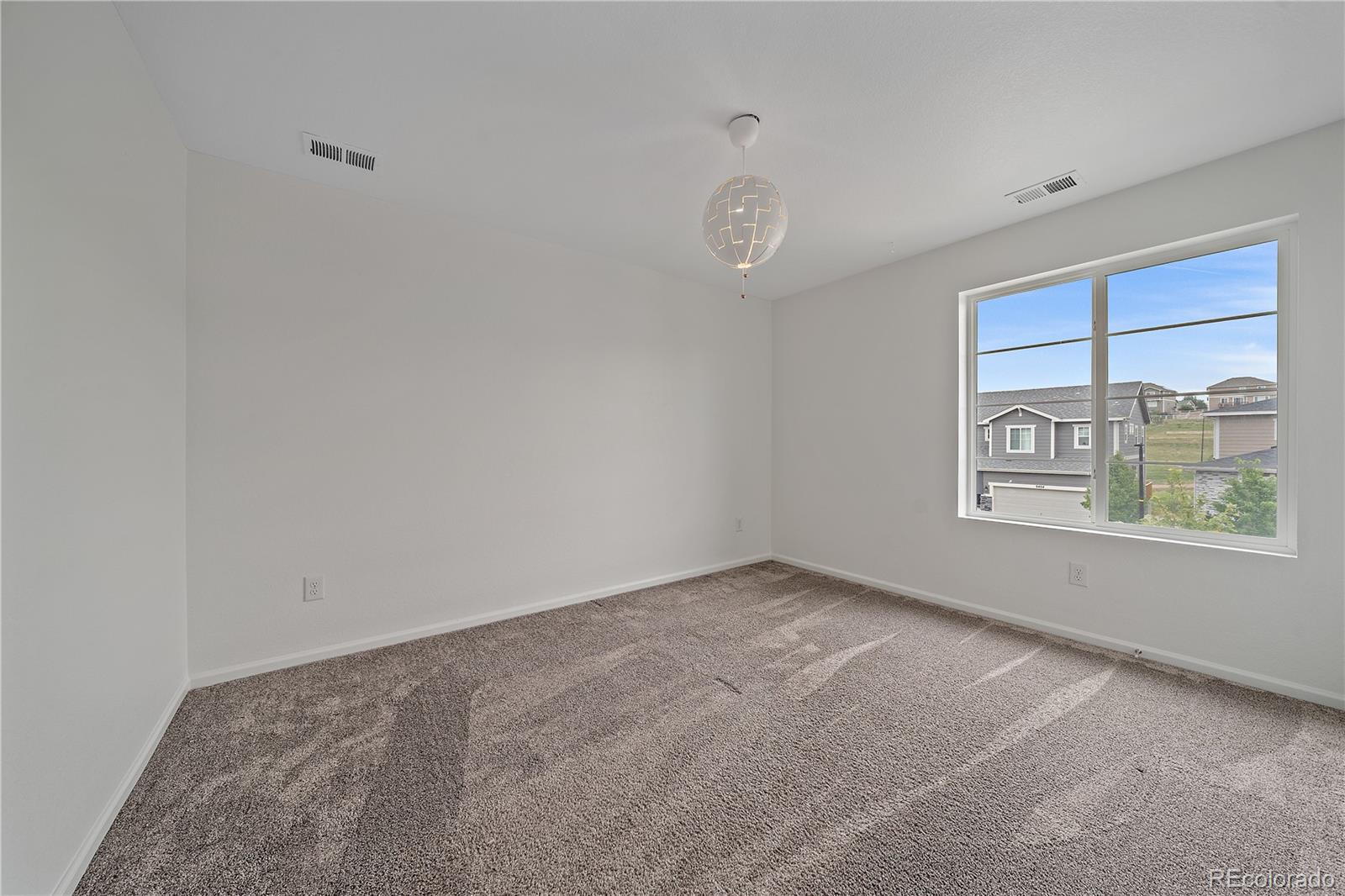 5465 Gray Wolf Lane Castle Rock, CO 80104 - Photo 17 of 21 an empty room with a empty space and windows