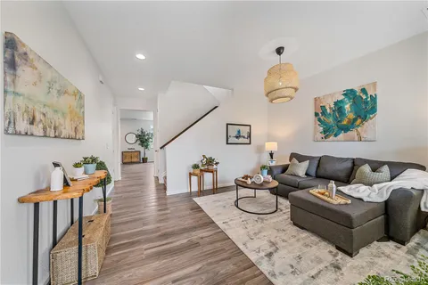 a living room with furniture a rug and a window