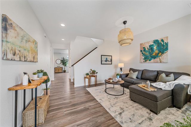 a living room with furniture a rug and a window