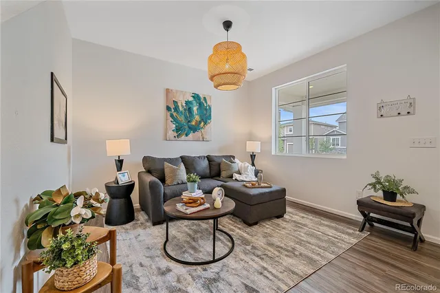 a living room with furniture dining table and a large window