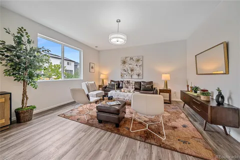 a kitchen with a table chairs refrigerator and microwave