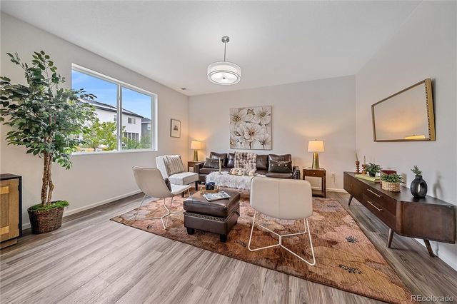a kitchen with a table chairs refrigerator and microwave