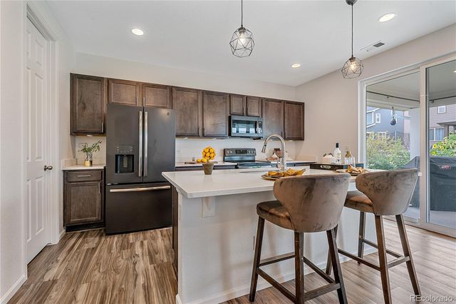 a kitchen with counter space sink appliances and cabinets