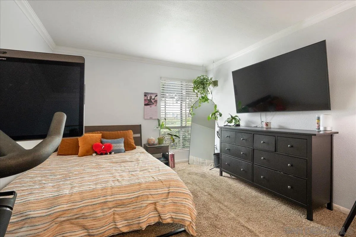 3579 Ruffin Road, Unit 105 San Diego, CA 92123 - Photo 13 of 23 a bedroom with a bed and a flat screen tv