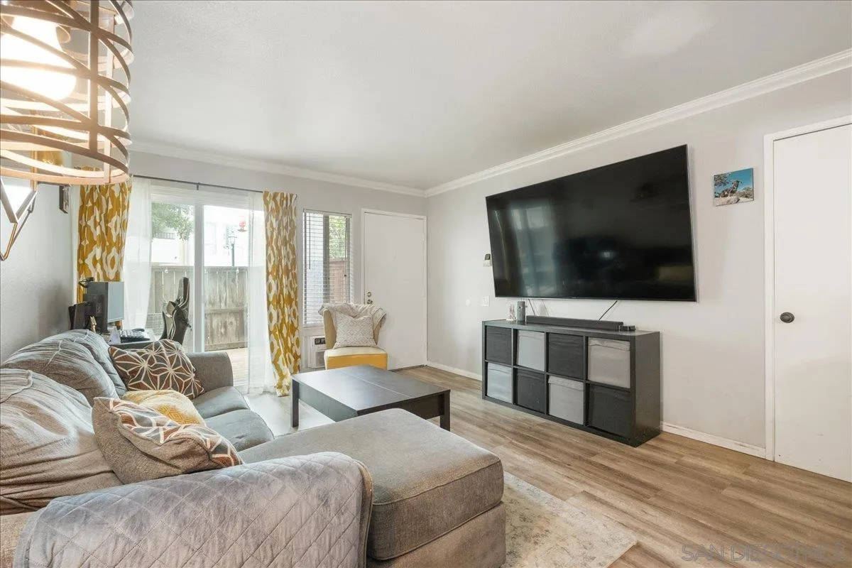 3579 Ruffin Road, Unit 105 San Diego, CA 92123 - Photo 4 of 23 a living room with furniture and a flat screen tv