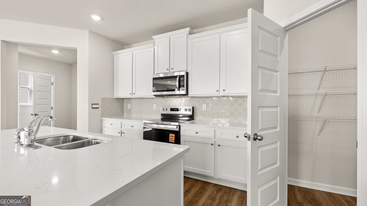 918 Stow Lane Monroe, GA 30655 - Photo 12 of 43 a kitchen with a sink a stove and cabinets
