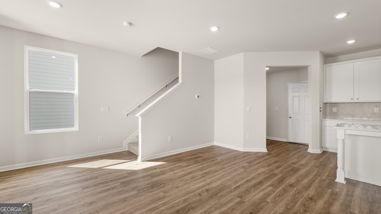 918 Stow Lane Monroe, GA 30655 - Photo 13 of 43 a view of empty room with wooden floor and fan
