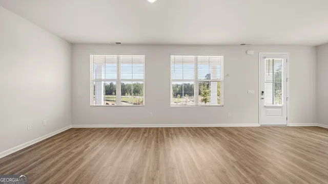a view of kitchen with wooden floor and electronic appliances