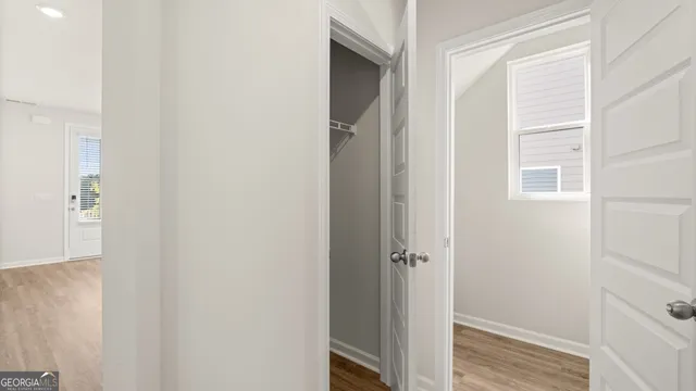 an empty room with closet and a bathroom