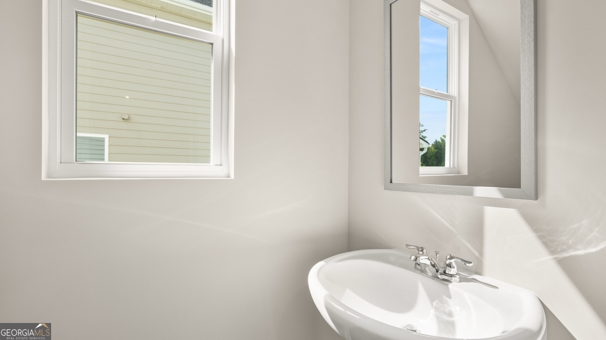 918 Stow Lane Monroe, GA 30655 - Photo 19 of 43 a bathroom with a sink a mirror and a window