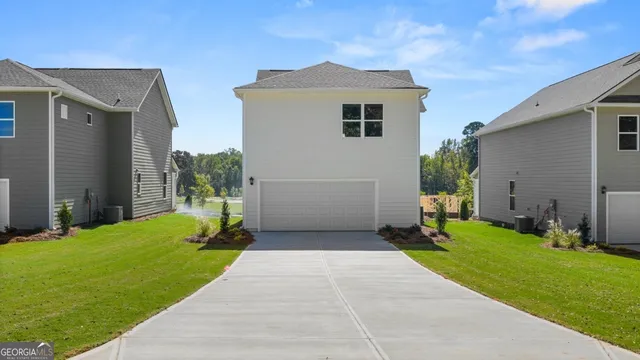 a front view of house with yard and green space
