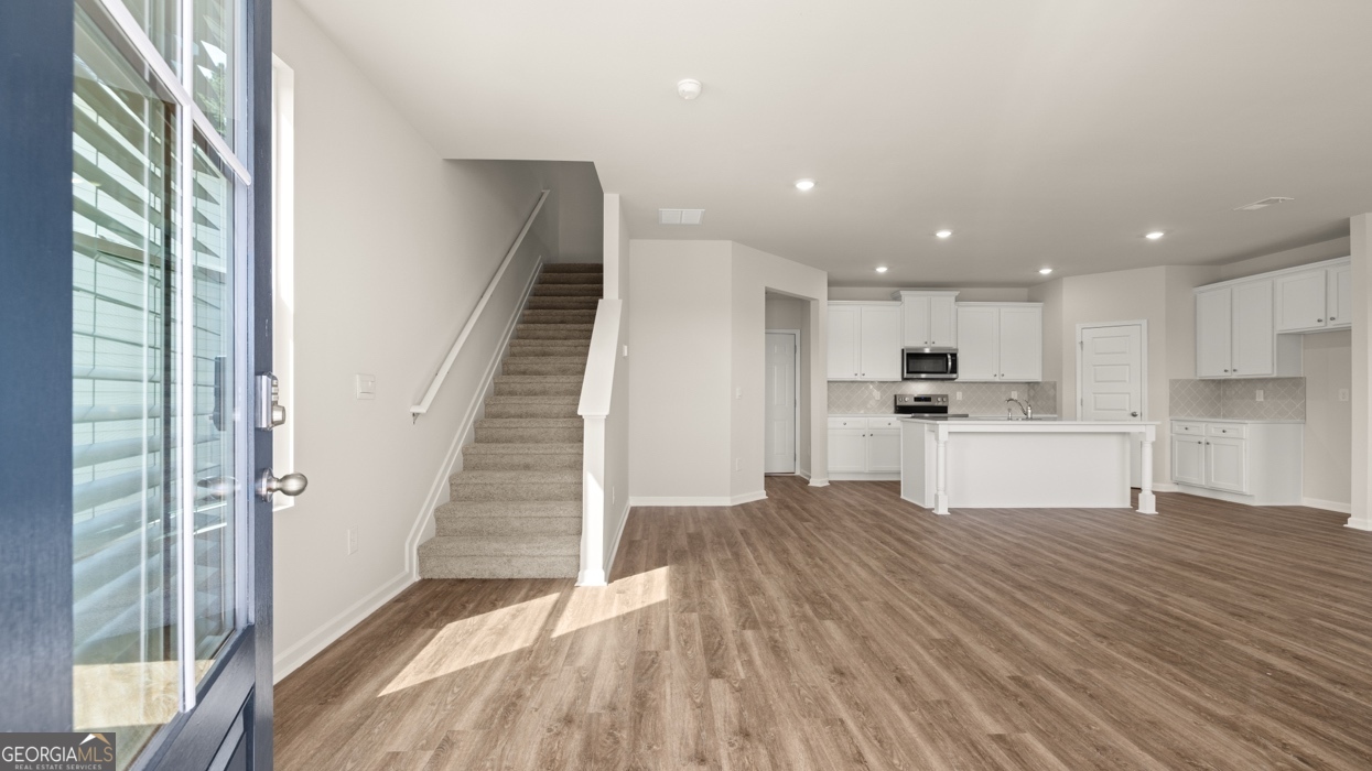 918 Stow Lane Monroe, GA 30655 - Photo 7 of 43 a view of kitchen with wooden floor and electronic appliances