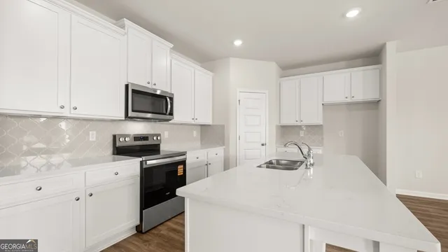 a kitchen with a sink a stove and cabinets