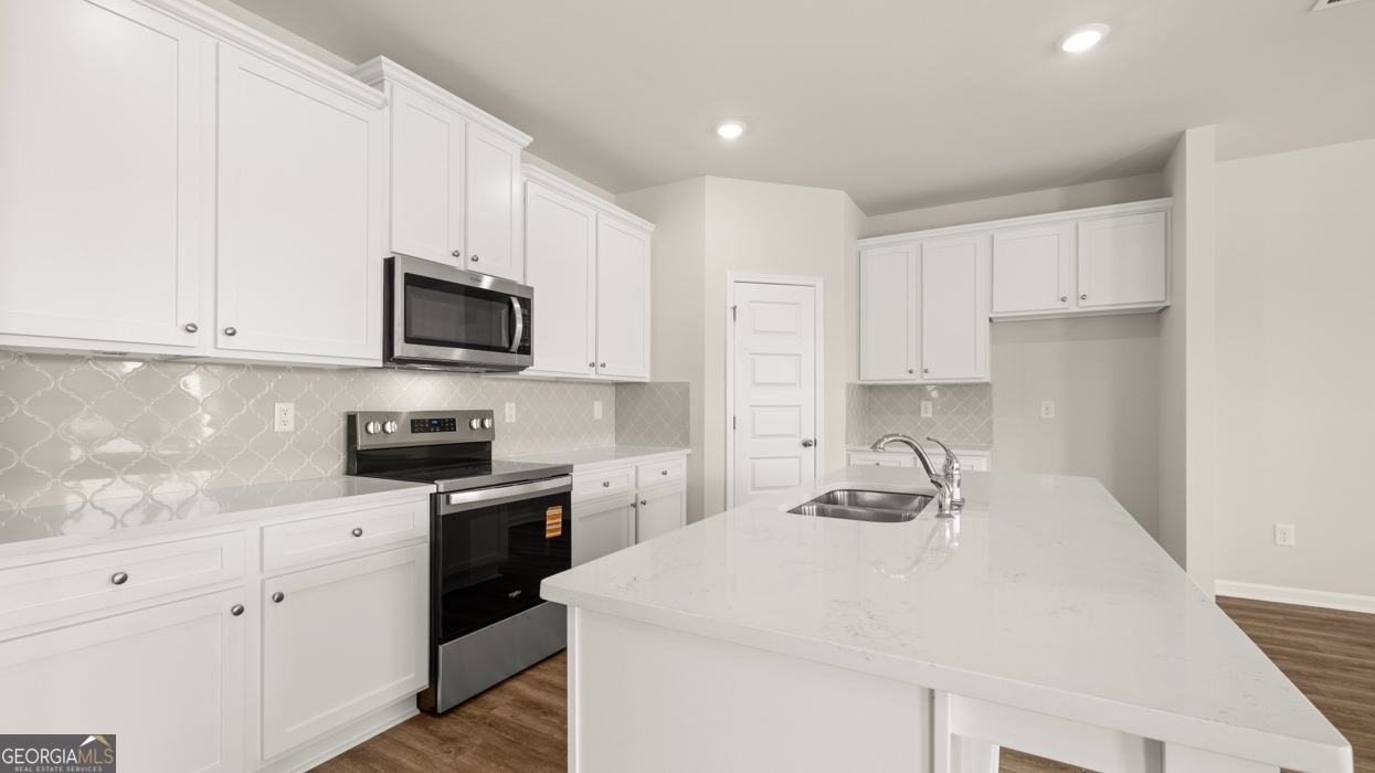 918 Stow Lane Monroe, GA 30655 - Photo 10 of 43 a kitchen with sink a microwave and cabinets