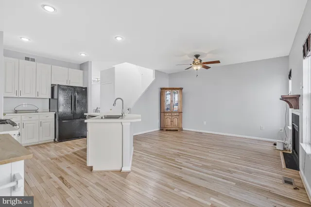 a kitchen with a refrigerator and a stove top oven