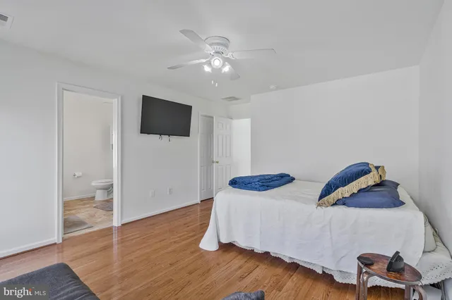 a bedroom with bed and a chandelier