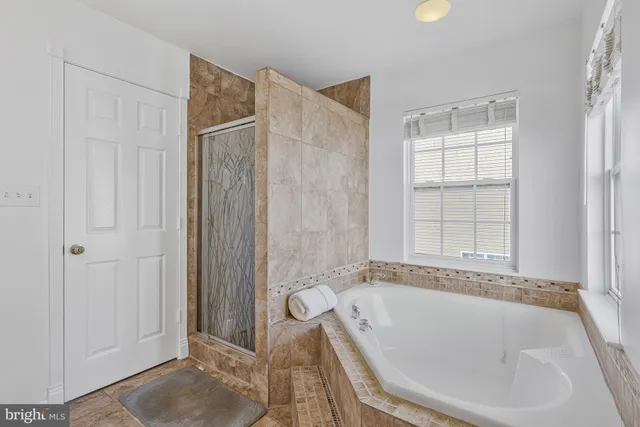 a bathroom with a tub and shower