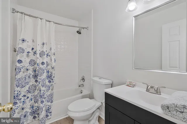 a bathroom with a sink toilet vanity and shower