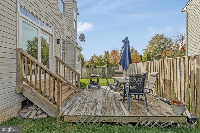 a view of a house with a small yard and wooden fence