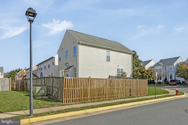 a view of a backyard with a fence