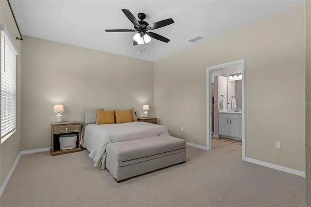 a view of a grassy field with trees in the background