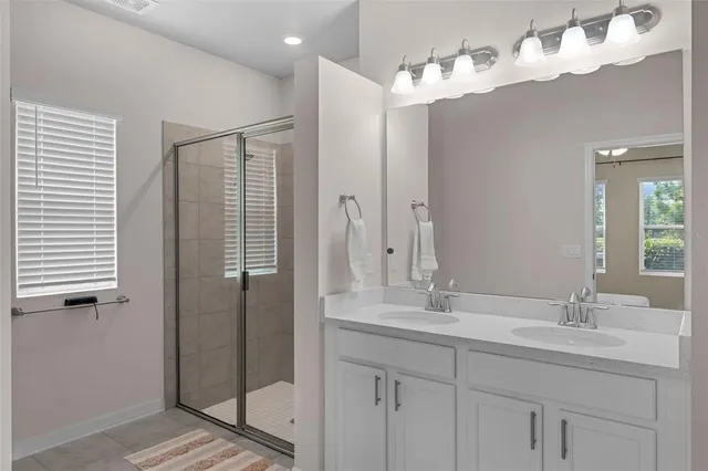 an aerial view of a house with a garden and a car parked