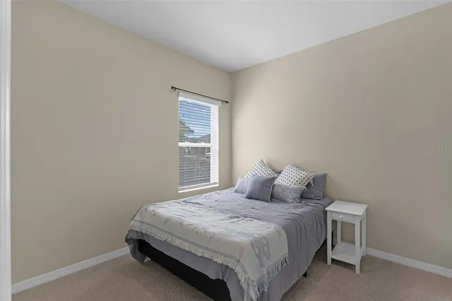 an aerial view of a house with a garden and lake view