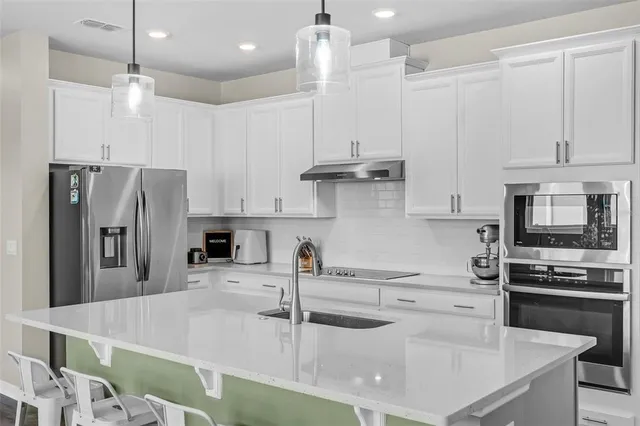 a bedroom with a bed chandelier and a window