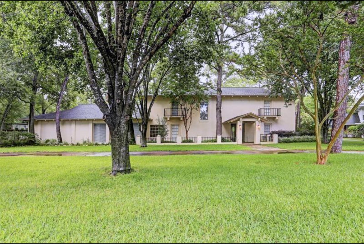 11910 Steppingstone Lane Houston, TX 77024 - Photo 1 of 14 a front view of a house with garden