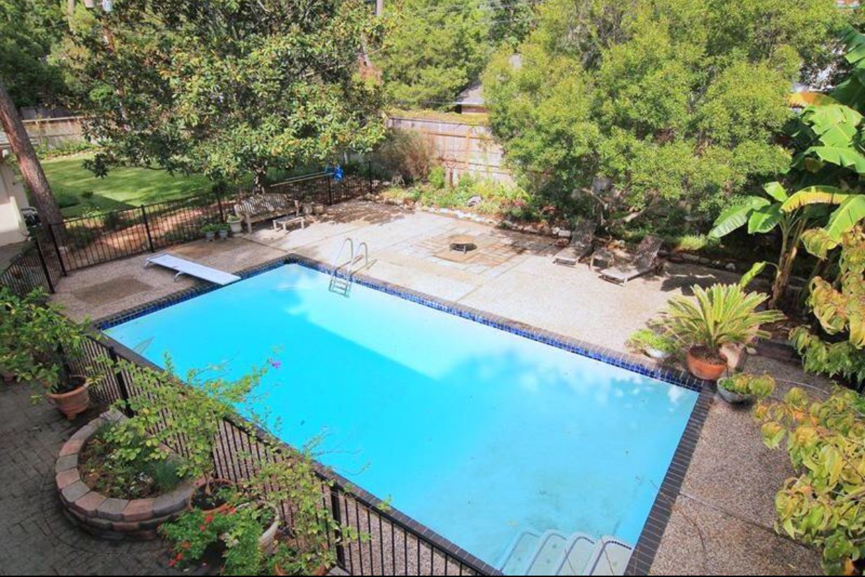 11910 Steppingstone Lane Houston, TX 77024 - Photo 14 of 14 a view of a swimming pool with a yard
