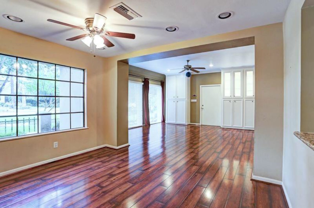 11910 Steppingstone Lane Houston, TX 77024 - Photo 2 of 14 a view of an empty room with wooden floor and a window