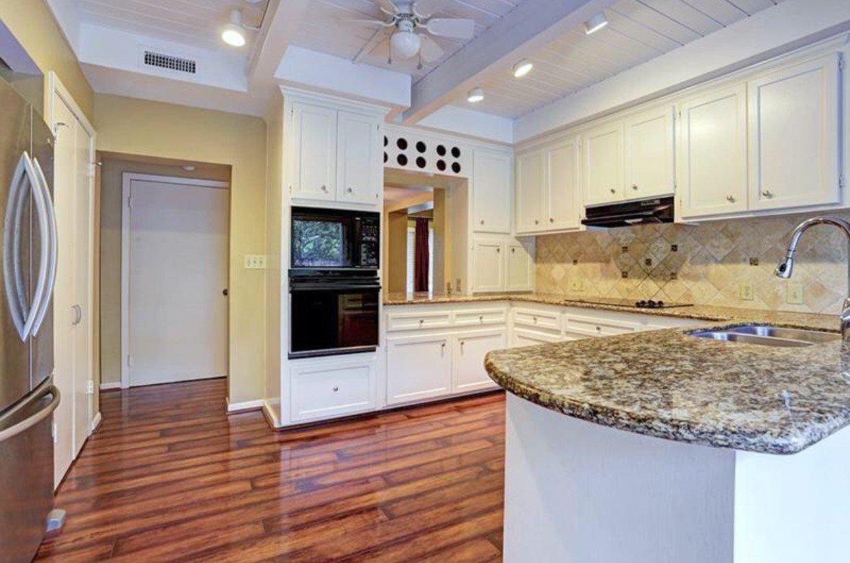 11910 Steppingstone Lane Houston, TX 77024 - Photo 5 of 14 a kitchen with kitchen island a counter top space appliances and cabinets