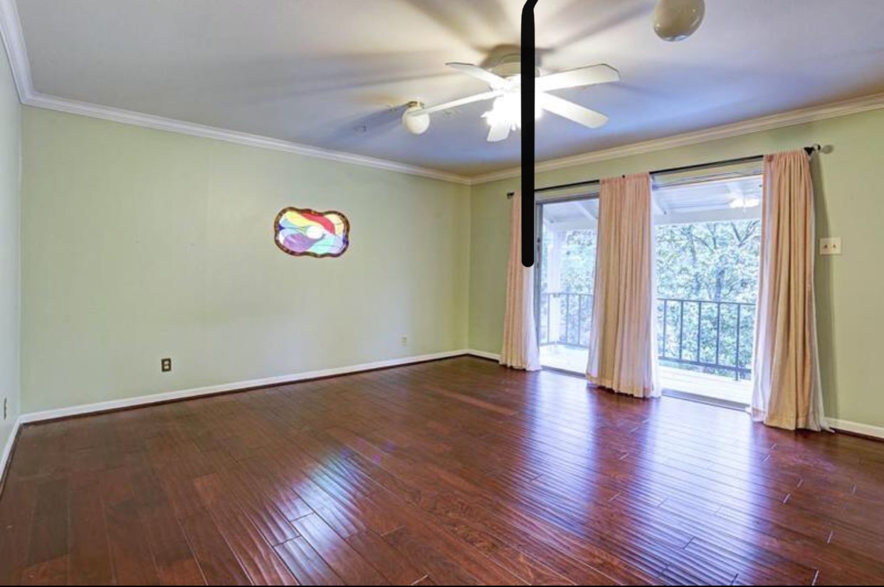 11910 Steppingstone Lane Houston, TX 77024 - Photo 7 of 14 a view of an empty room with wooden floor and a window