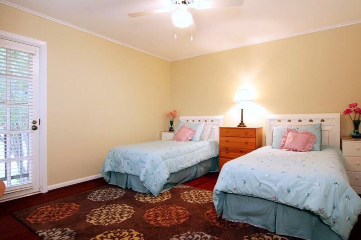 11910 Steppingstone Lane Houston, TX 77024 - Photo 10 of 14 a bedroom with two beds and a window