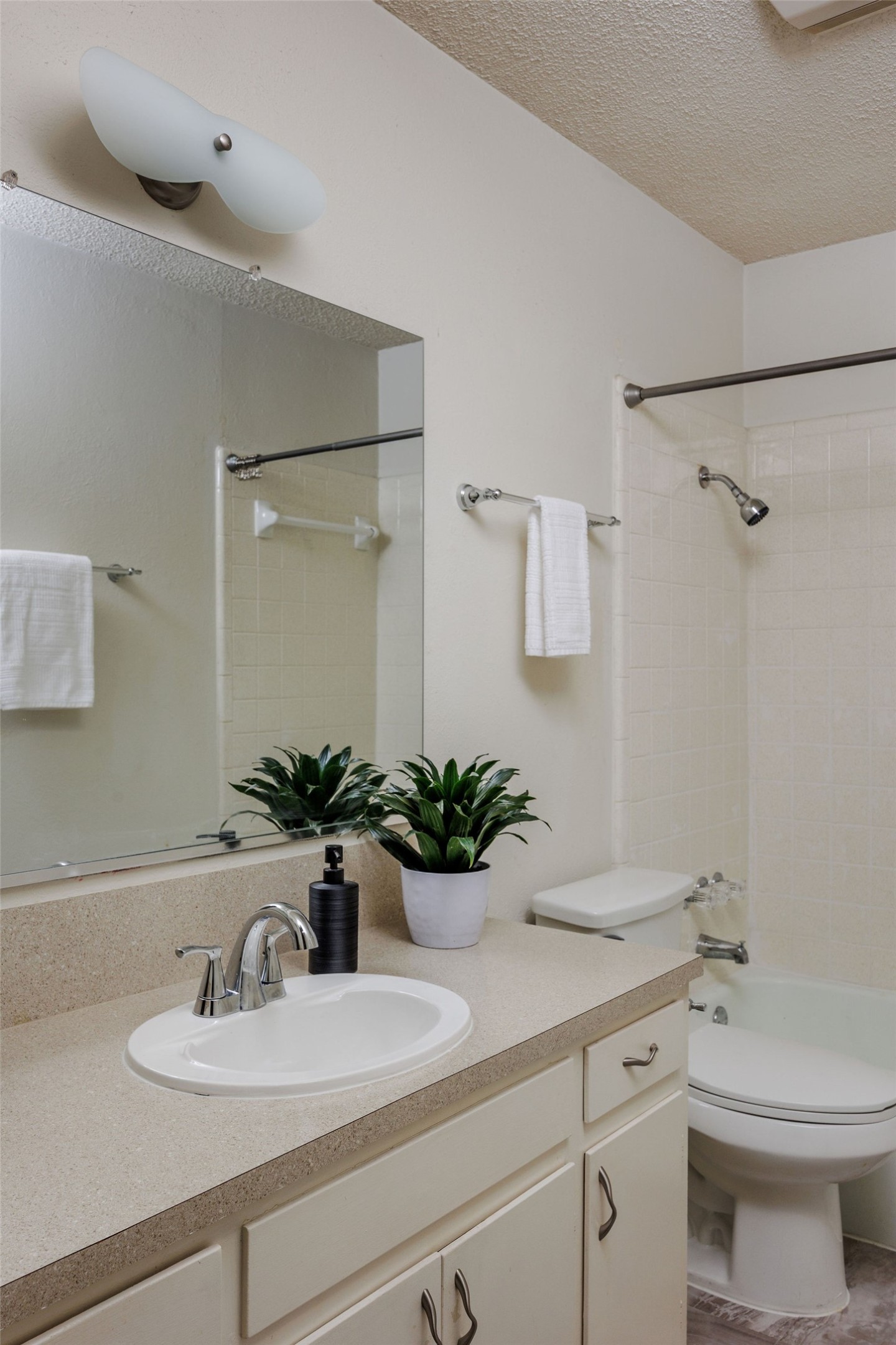 2012 Cody Court Austin, TX 78704 - Photo 18 of 40 A well-maintained bathroom with a spacious vanity, large mirror, and tiled shower area.