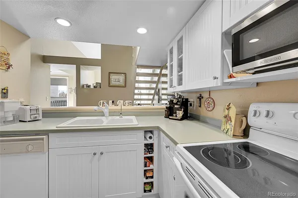 a kitchen with a sink stove and cabinets