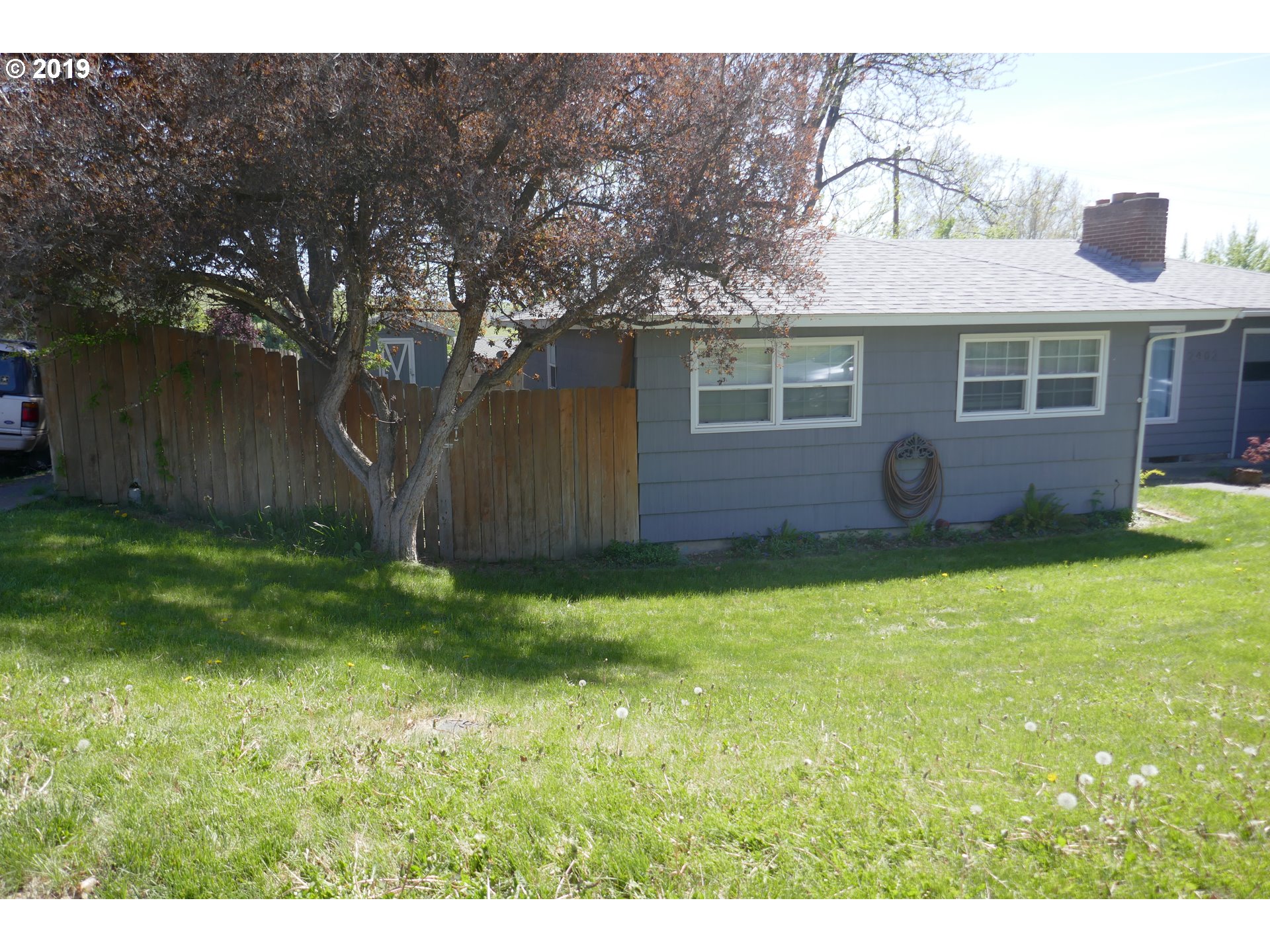 2402 Southwest Olson Avenue Pendleton, OR 97801 - Photo 5 of 26 a view of a backyard with potted plants and large tree