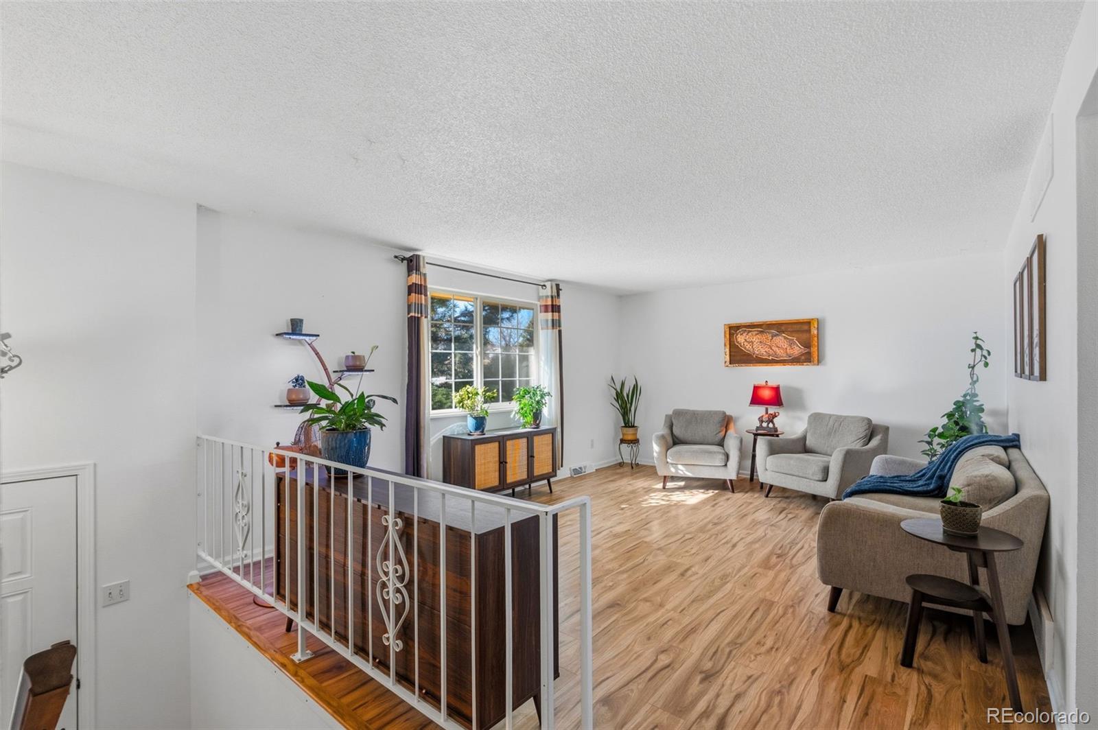 357 Saturn Place Lone Tree, CO 80124 - Photo 12 of 39 a living room with furniture and wooden floor